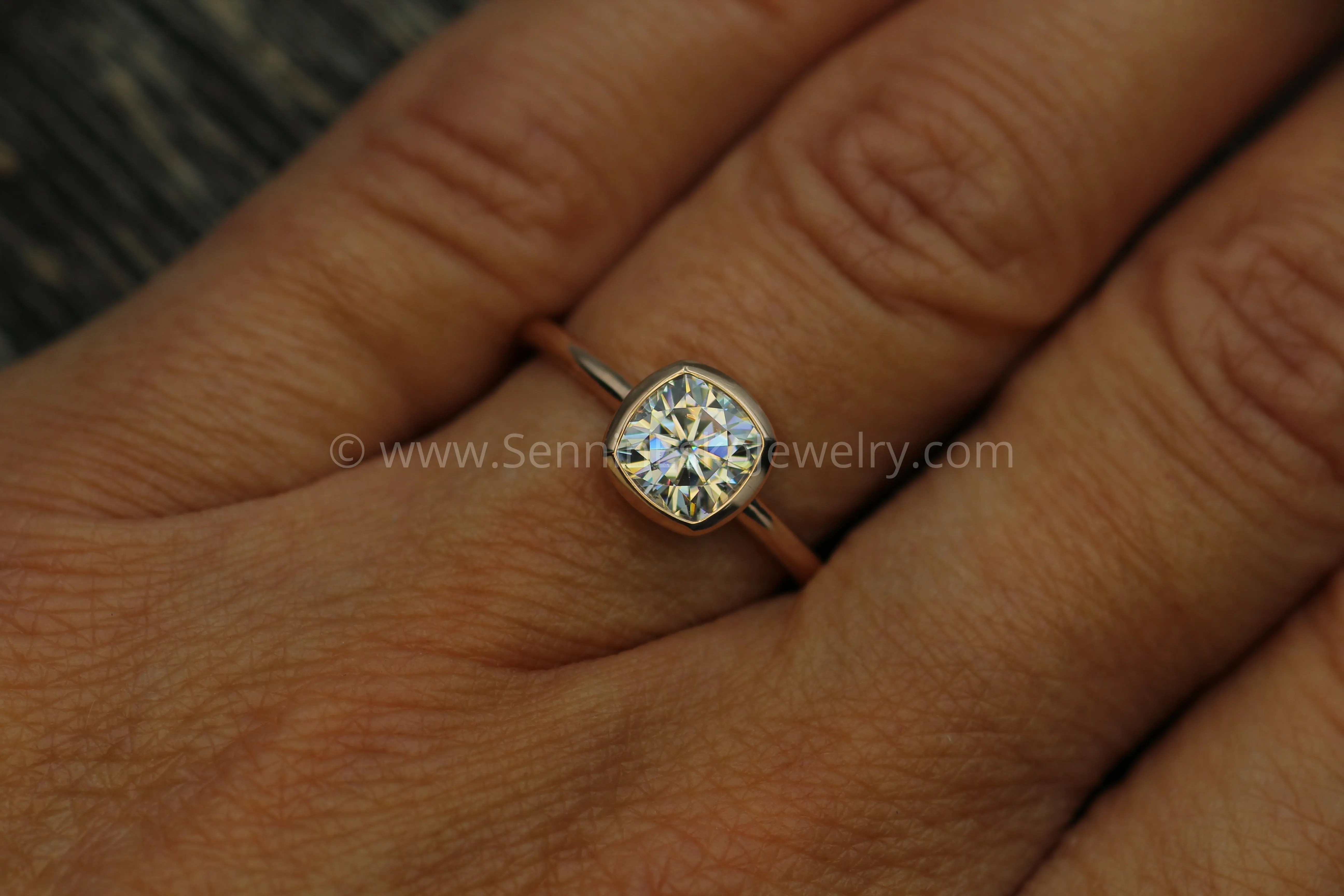 Colorless Moissanite 6x6mm Cushion Cut Bezel Solitaire Ring With A Medium/Lightweight Band