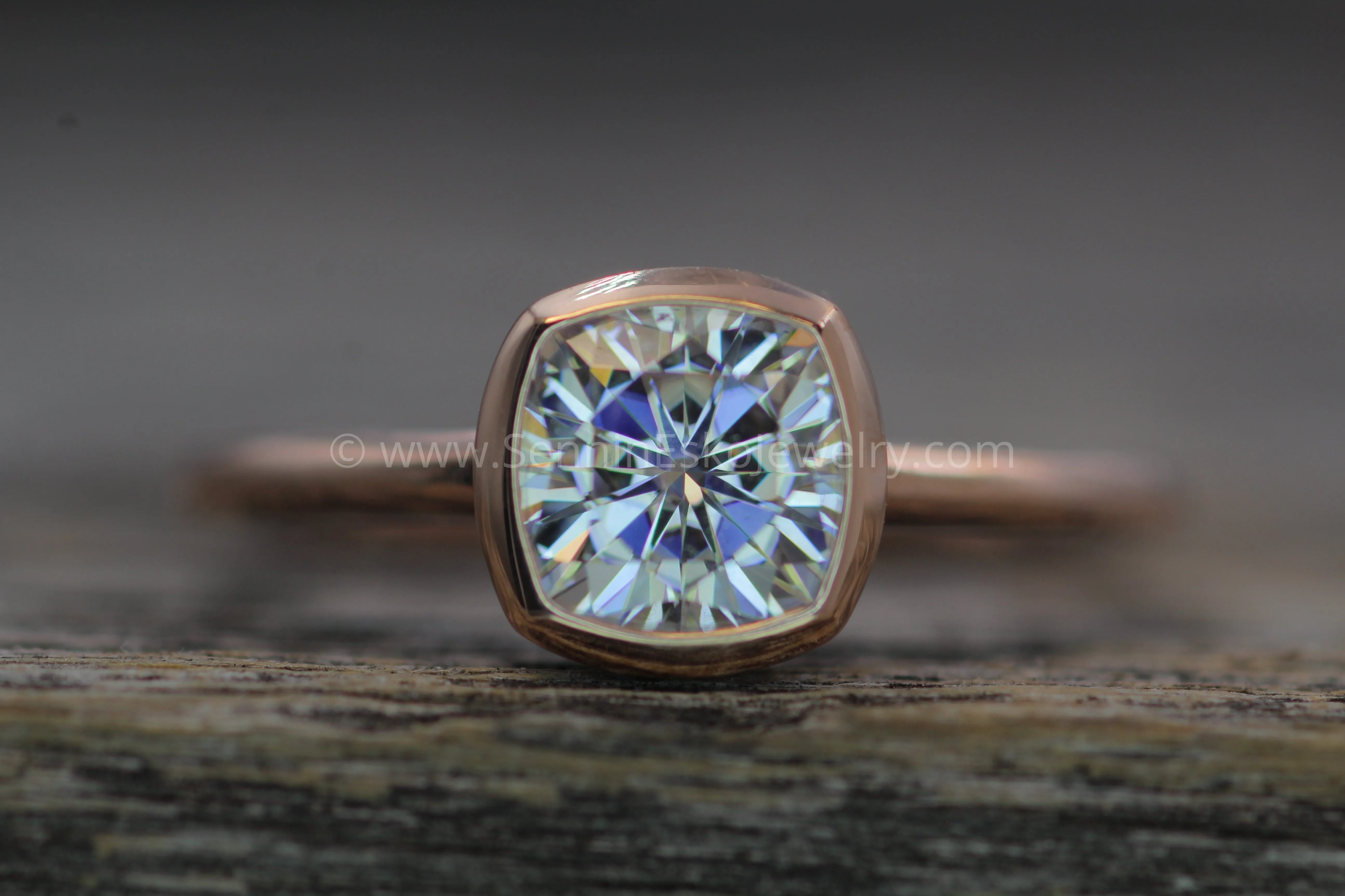 Colorless Moissanite 6x6mm Cushion Cut Bezel Solitaire Ring With A Medium/Lightweight Band
