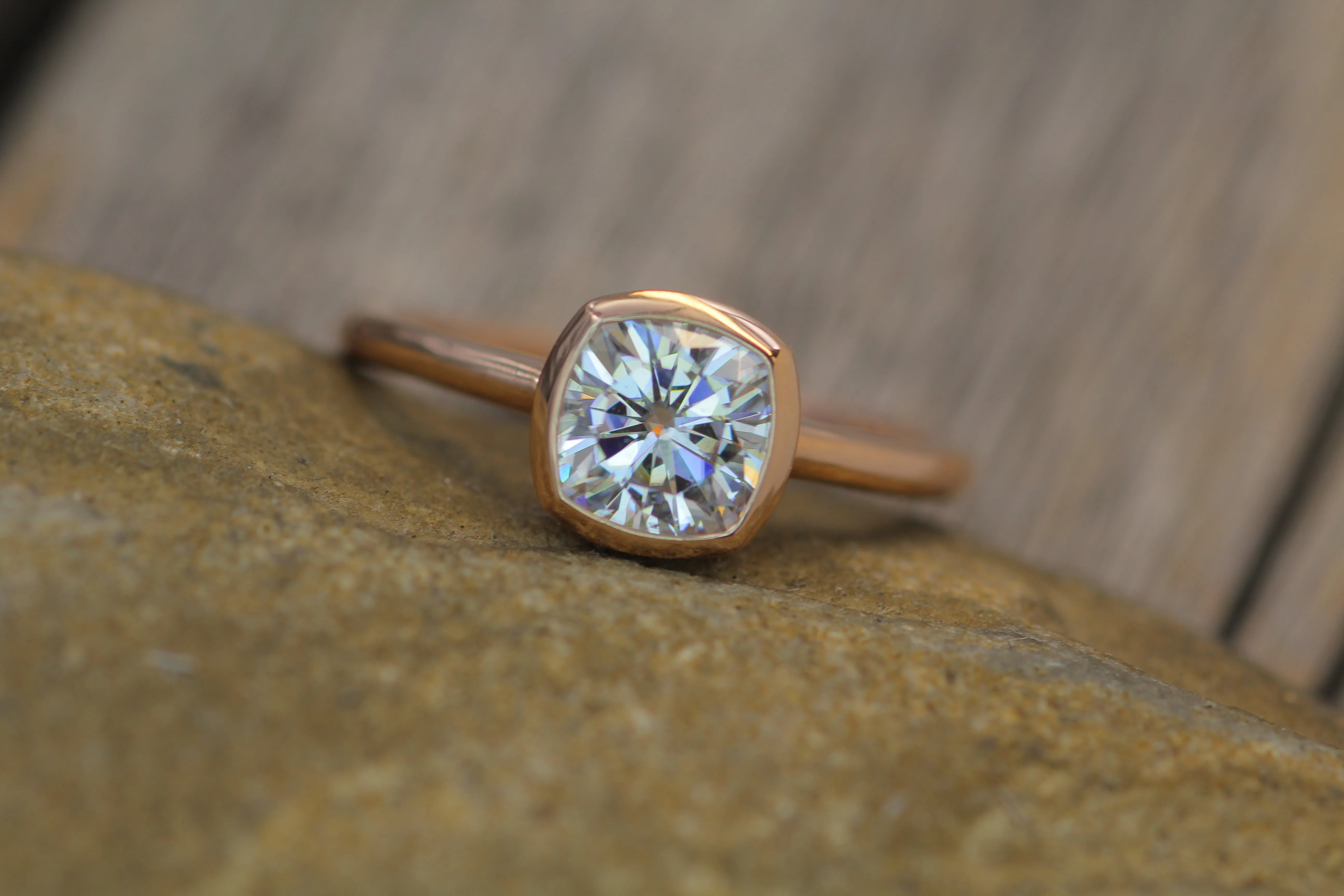 Colorless Moissanite 6x6mm Cushion Cut Bezel Solitaire Ring With A Medium/Lightweight Band