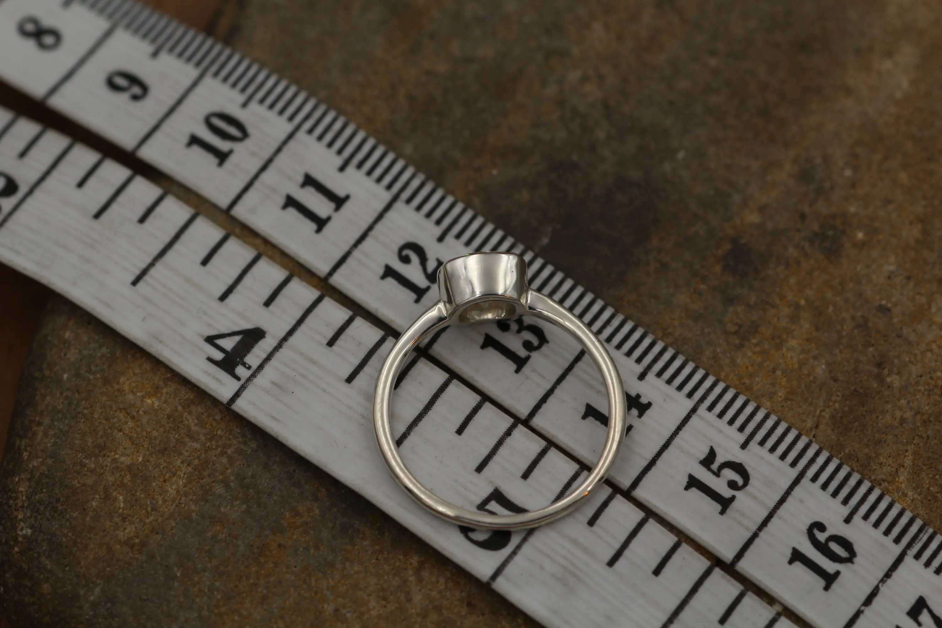 Colorless Moissanite 6x6mm Cushion Cut Bezel Solitaire Ring With A Medium/Lightweight Band