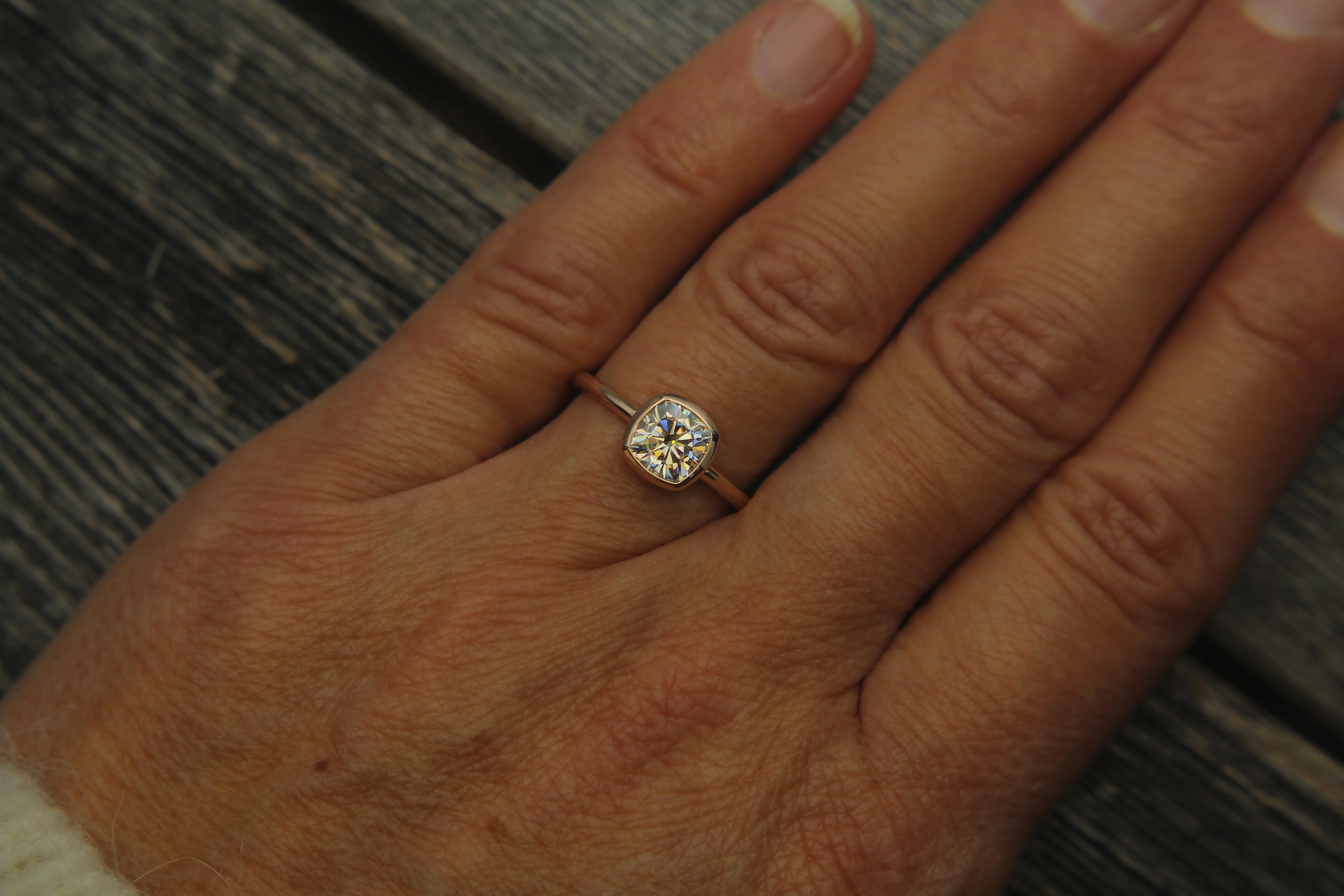Colorless Moissanite 6x6mm Cushion Cut Bezel Solitaire Ring With A Medium/Lightweight Band