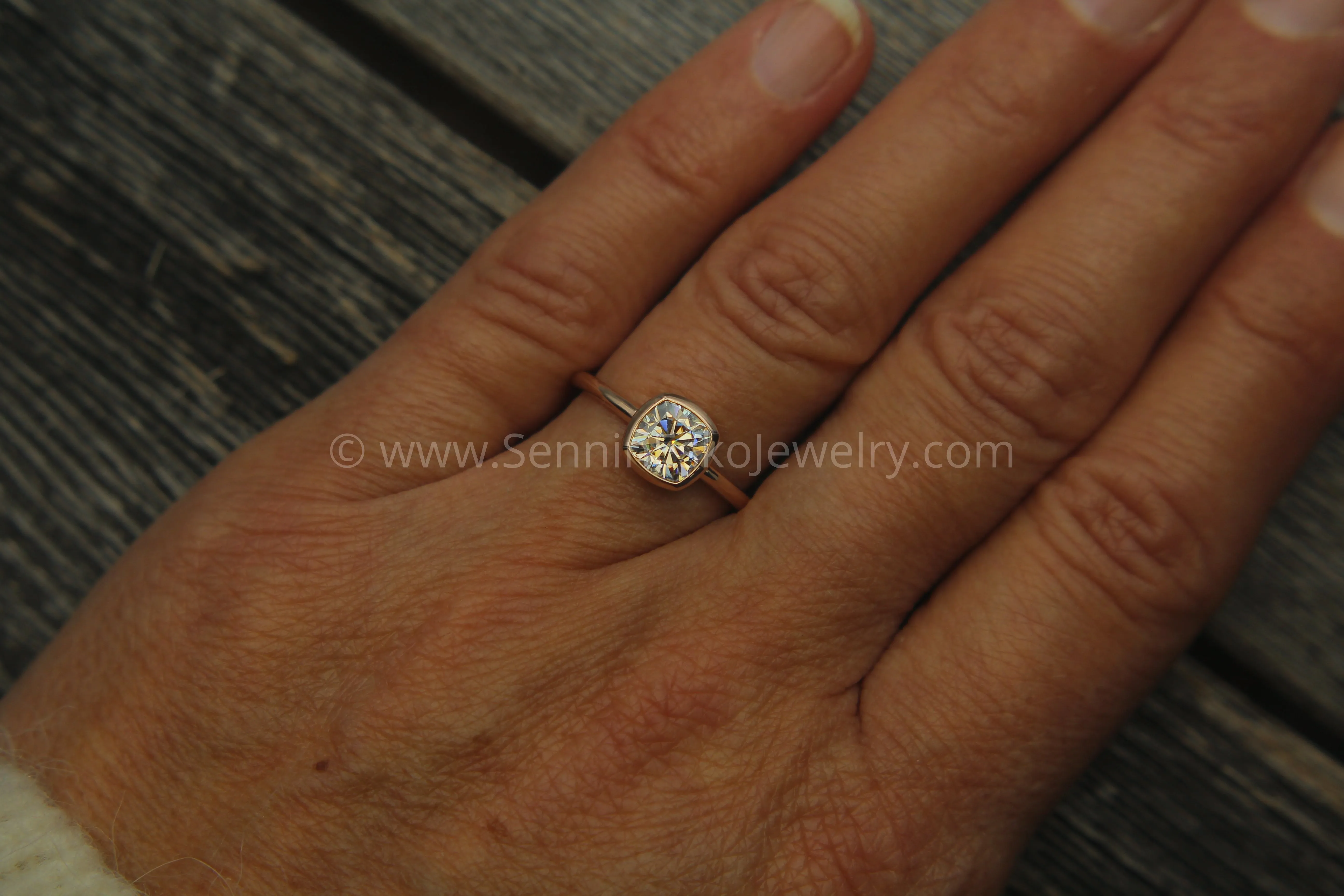 Colorless Moissanite 6x6mm Cushion Cut Bezel Solitaire Ring With A Medium/Lightweight Band