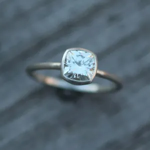 Colorless Moissanite 6x6mm Cushion Cut Bezel Solitaire Ring With A Medium/Lightweight Band