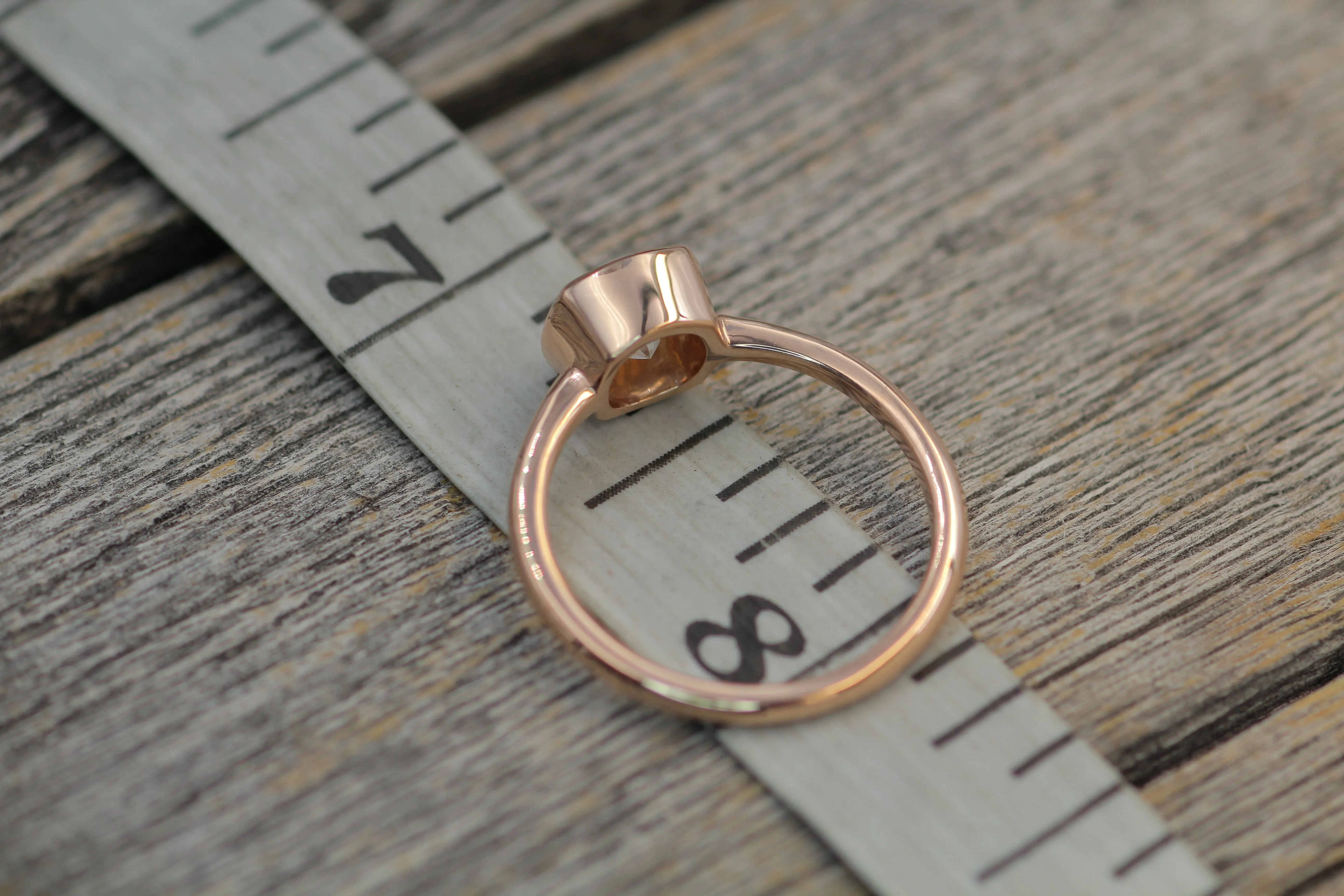 Colorless Moissanite 6x6mm Cushion Cut Bezel Solitaire Ring With A Medium/Lightweight Band