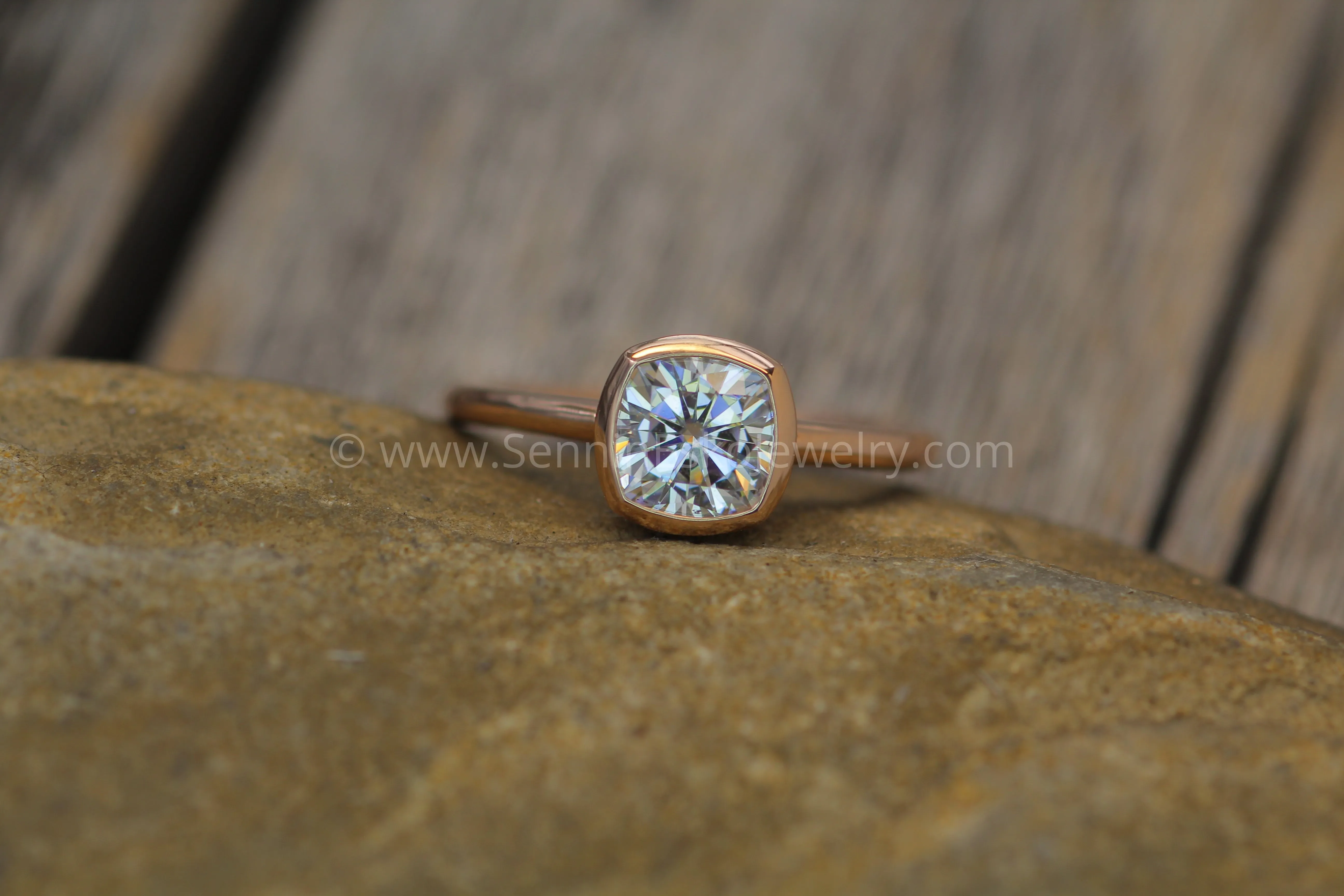 Colorless Moissanite 6x6mm Cushion Cut Bezel Solitaire Ring With A Medium/Lightweight Band
