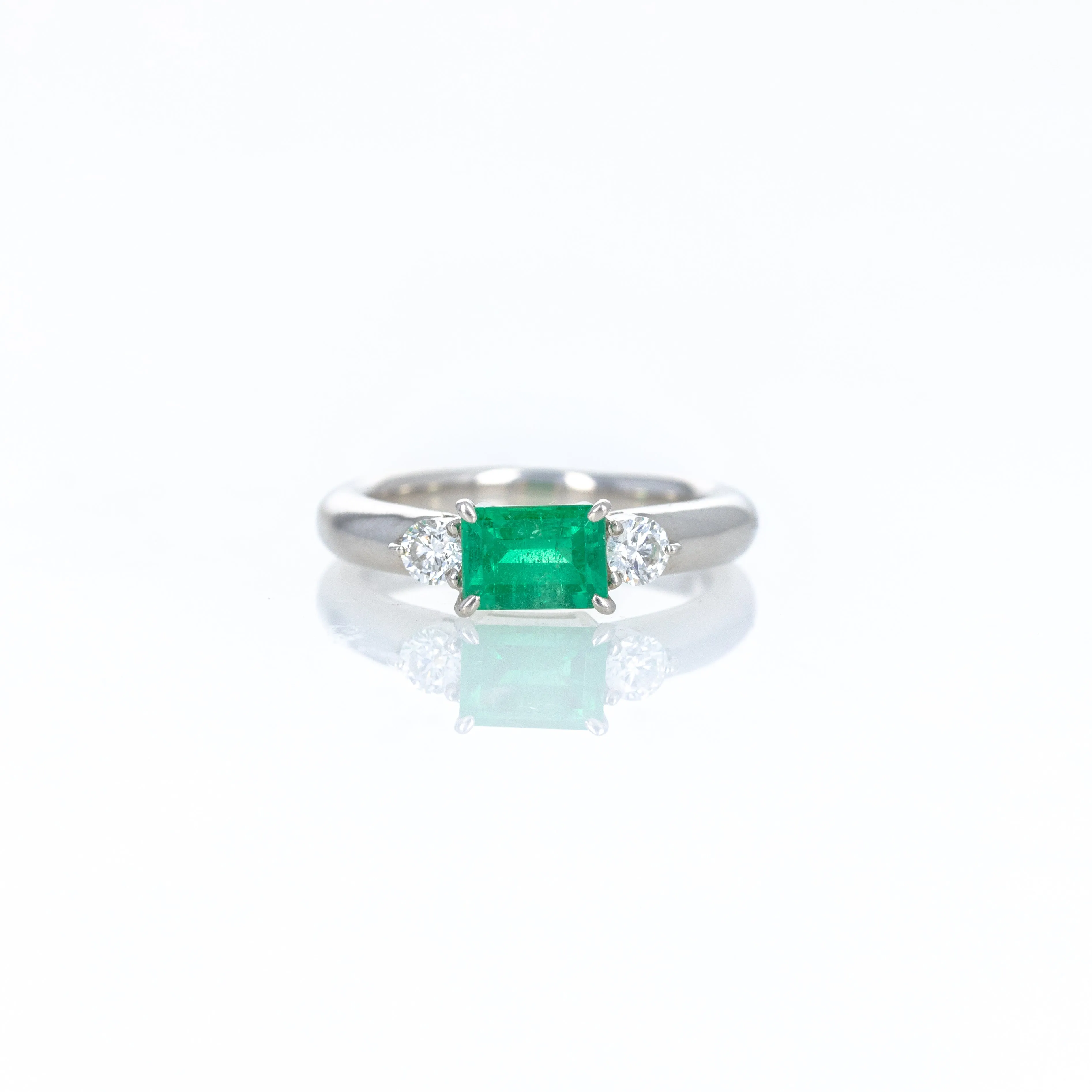Platinum 0.71 Carat Emerald Diamond Three Stone Ring