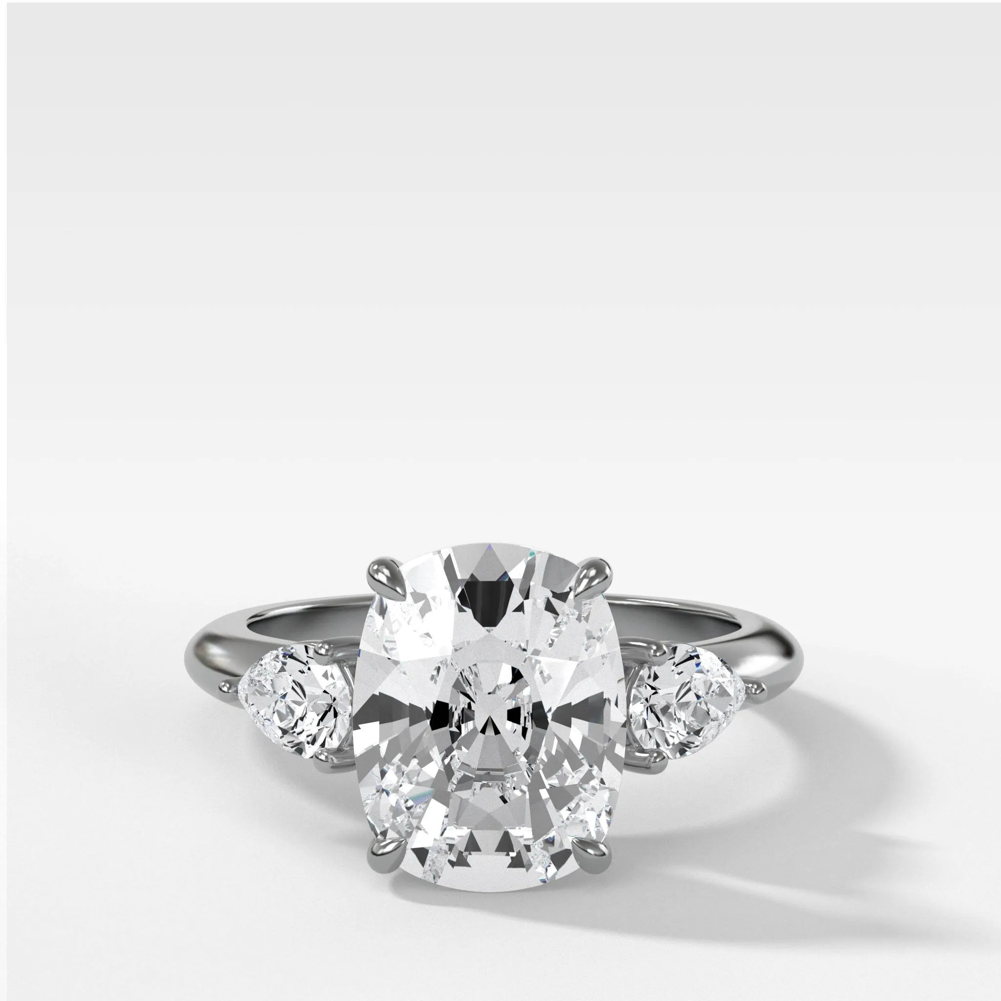 Three Stone Engagement Ring With Pear Side Stones and Elongated Cushion Cut Diamond