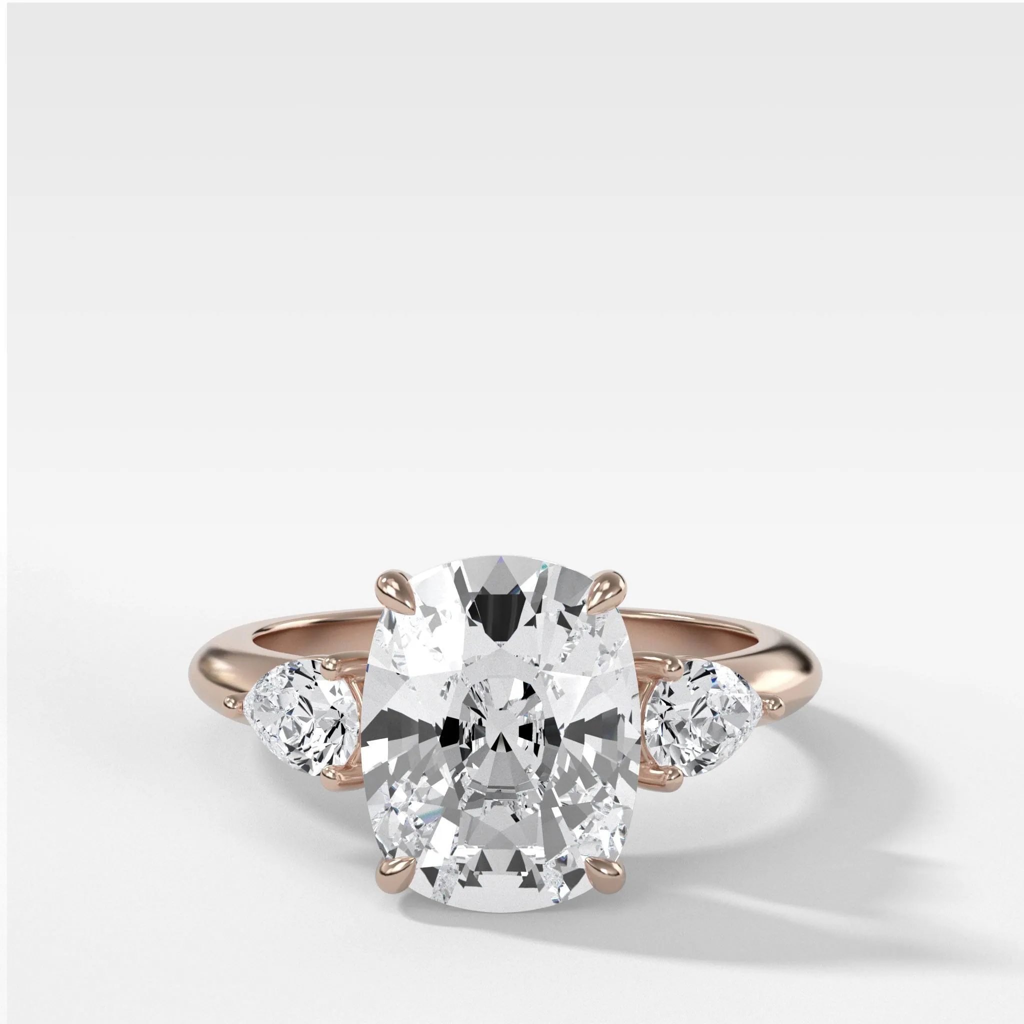 Three Stone Engagement Ring With Pear Side Stones and Elongated Cushion Cut Diamond