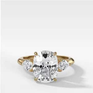 Three Stone Engagement Ring With Pear Side Stones and Elongated Cushion Cut Diamond